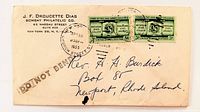 Front of envelope showing stamps, postmark, printed return address and recipient address