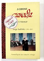 Front cover showing title, signed copy sticker, photo, design