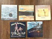 Front covers of the five LP records arranged on floor