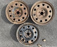 Three rims front face showing rust and vent holes