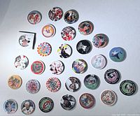 Top view of 30 assorted pogs laid out