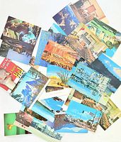 Pile of assorted postcards with varied imagery