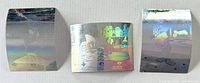 front view of three hologram trading cards