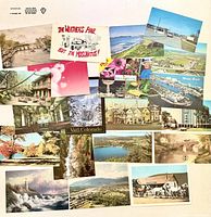Fronts of the assorted postcards laid out showing variety of images