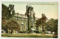 Front of colour postcard showing hospital building and grounds