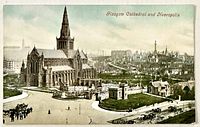 Front image of colour postcard showing Glasgow Cathedral, necropolis and horse-drawn carts