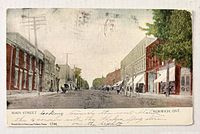 Front of postcard showing street scene, caption and number 1744