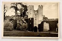 Front of postcard showing Warwick Castle clock tower