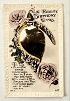 Front view showing black cat, horseshoe, roses and printed message