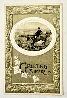 Front of embossed postcard showing mounted rider, text and floral border