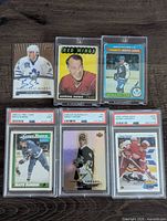 Six highlighted cards including three PSA slabs, Gordie Howe card, Glacial Marks auto, Toronto Maple Leafs All-Star