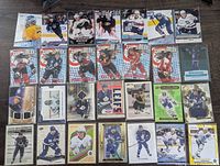 Fronts of 25 assorted hockey cards showing inserts, jersey cards and star players