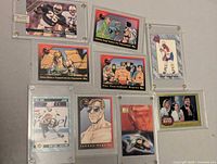 Overall view of nine trading cards in holders
