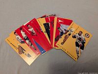 Fan arrangement of several yellow-front Parkhurst Tallboys hockey cards