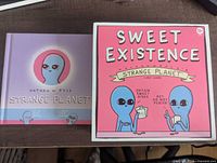 Front of both Strange Planet book and Sweet Existence card game