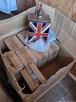 Shipping box with six individually boxed Union Jack ceramic canisters and one sample unboxed on bubble wrap