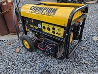 Full view Champion yellow/black portable generator with wheels and handle
