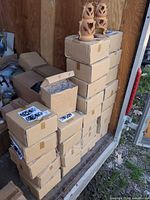 Stacked cartons containing boxed pairs of lanterns