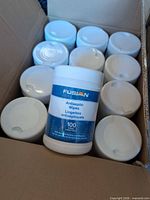 Open carton showing multiple white canisters, one labeled Fusion Antiseptic Wipes 100 count