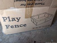 Cardboard box marked Play Fence