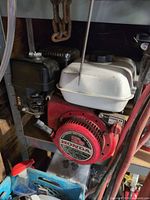 Full view of Honda GX140 engine mounted on shelf