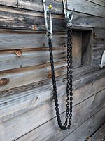 Full view of one chain sling hanging, showing chain length and hardware