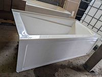 Oblique view of bathtub exterior showing apron and clean glossy finish