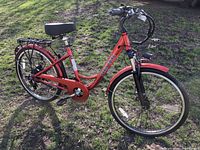 Left side view of complete red Paris Ebike showing frame, wheels, rack, and fenders