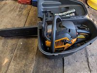 Chainsaw inside hard case with bar cover attached