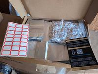 Open box showing stacks of Mylar bags, label sheet and instruction card