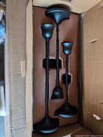 Three black metal candle holders inside box