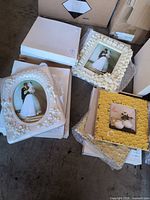 Stack of ivory and yellow frames, some boxed