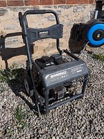 Pressure washer front view showing Simoniz branding, frame, pump, engine