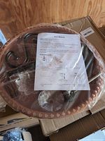 Boxed bird bath kit showing basin, bracket, pump, manual and hardware