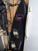 Full view of SurfKat ski board leaning against surface showing overall size, color, bindings and fin