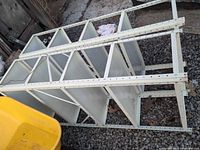 Shelving unit on side showing metal frame and plastic panels