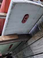 underside of windsurf board showing red fin box, dirt and wear