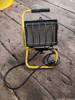 Front view showing stand, lamp housing, wire guard, power cord