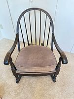 Front view showing spindle back, arms, and seat cushion