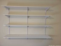 Shelving system assembled on wall showing three tiers