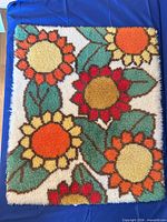 Square woven rug with sunflower pattern