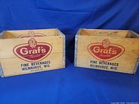 Two Graf's Premium wooden beverage crates side by side