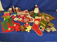 Overview of lot showing stockings, plush figures, mugs and crocheted ornaments