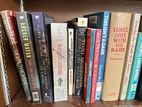 Shelf showing assorted mystery and fiction titles including Archer Mayor, Sharyn McCrumb, Brad Meltzer, Toni Morrison