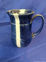 Blue pitcher showing glaze pattern and form