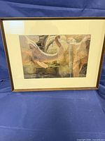Front view of framed elephant print in wood frame with mat