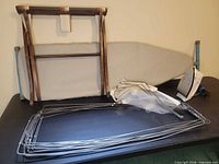 Overall lot showing ironing board, luggage rack, pant stretcher stack, iron