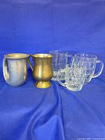 Group shot of all five mugs showing materials and styles