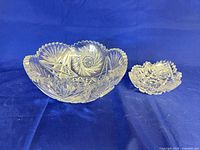 Large clear cut-glass bowl beside smaller bowl