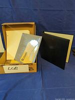 Entire lot: binder, sealed protector pack, loose pages inside box